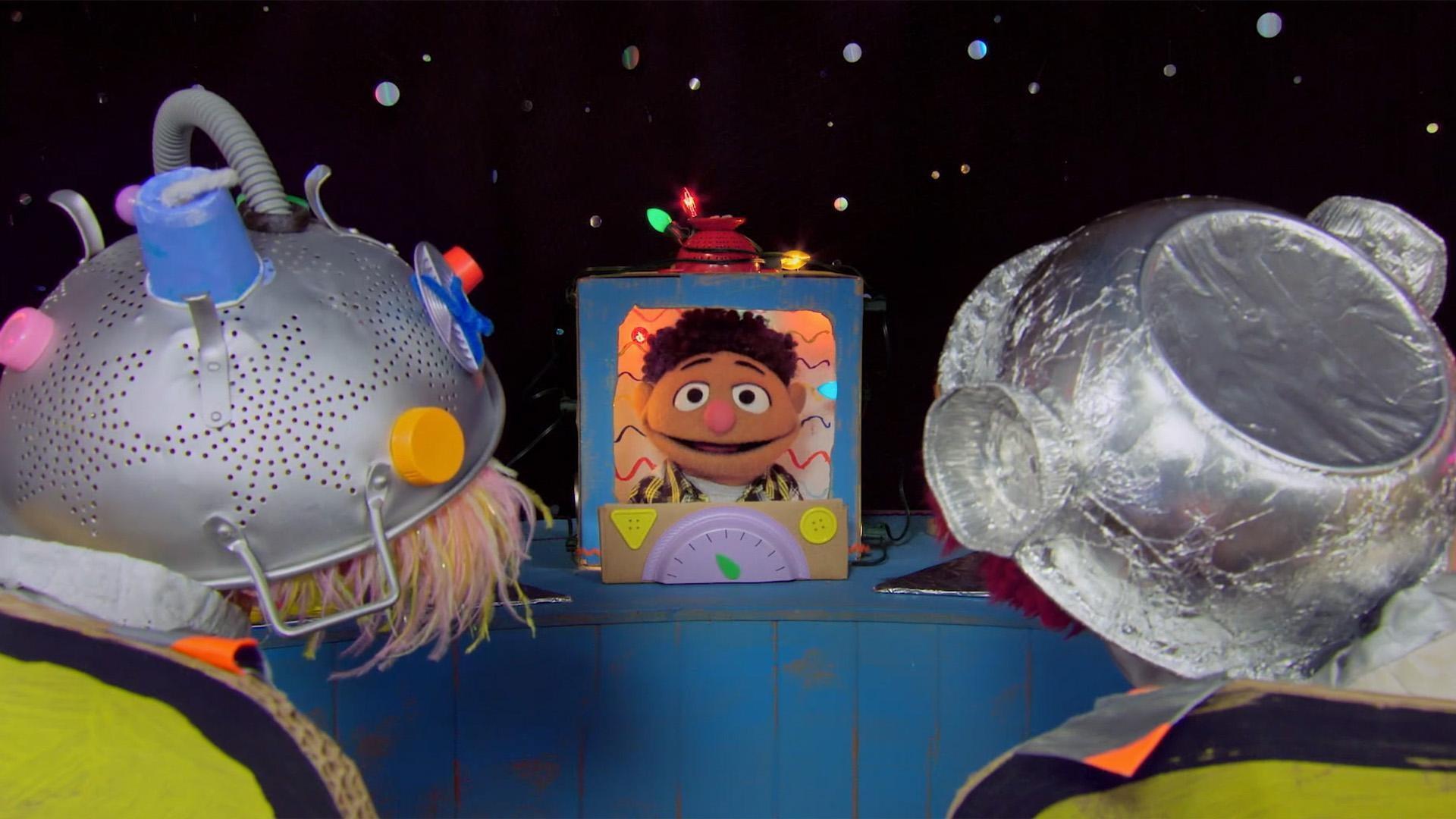 Tamir narrates a story about Zoe and Elmo as Astronauts on the moon.
